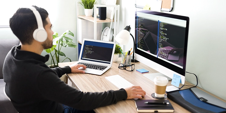 Laptop Screen Displaying Custom Web Development Code on Wooden Desk